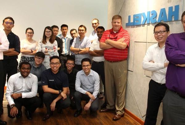 澳门足彩app employees posing with 澳门足彩app signage.